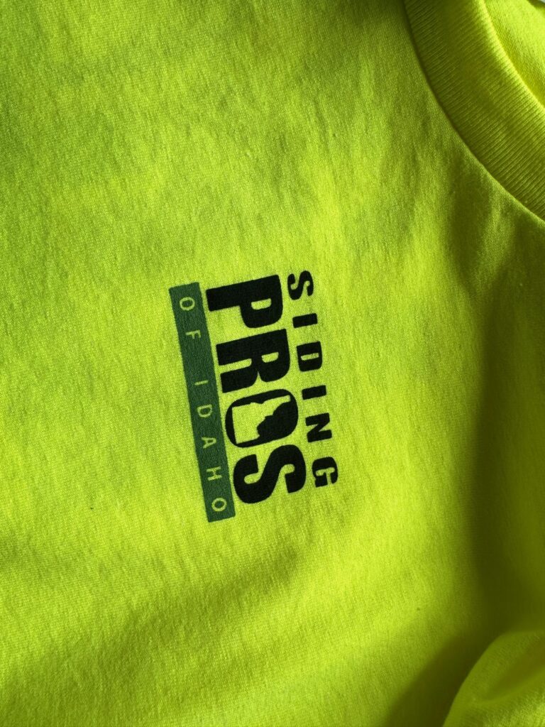 Screen printed left chest logo on safety green t-shirts for a local business in Nampa