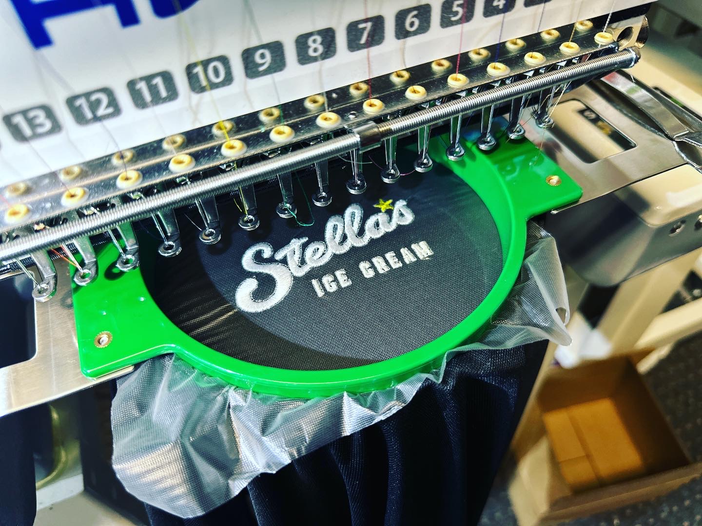 Custom polo embroidery on the machine at The Print Plug embroidery shop