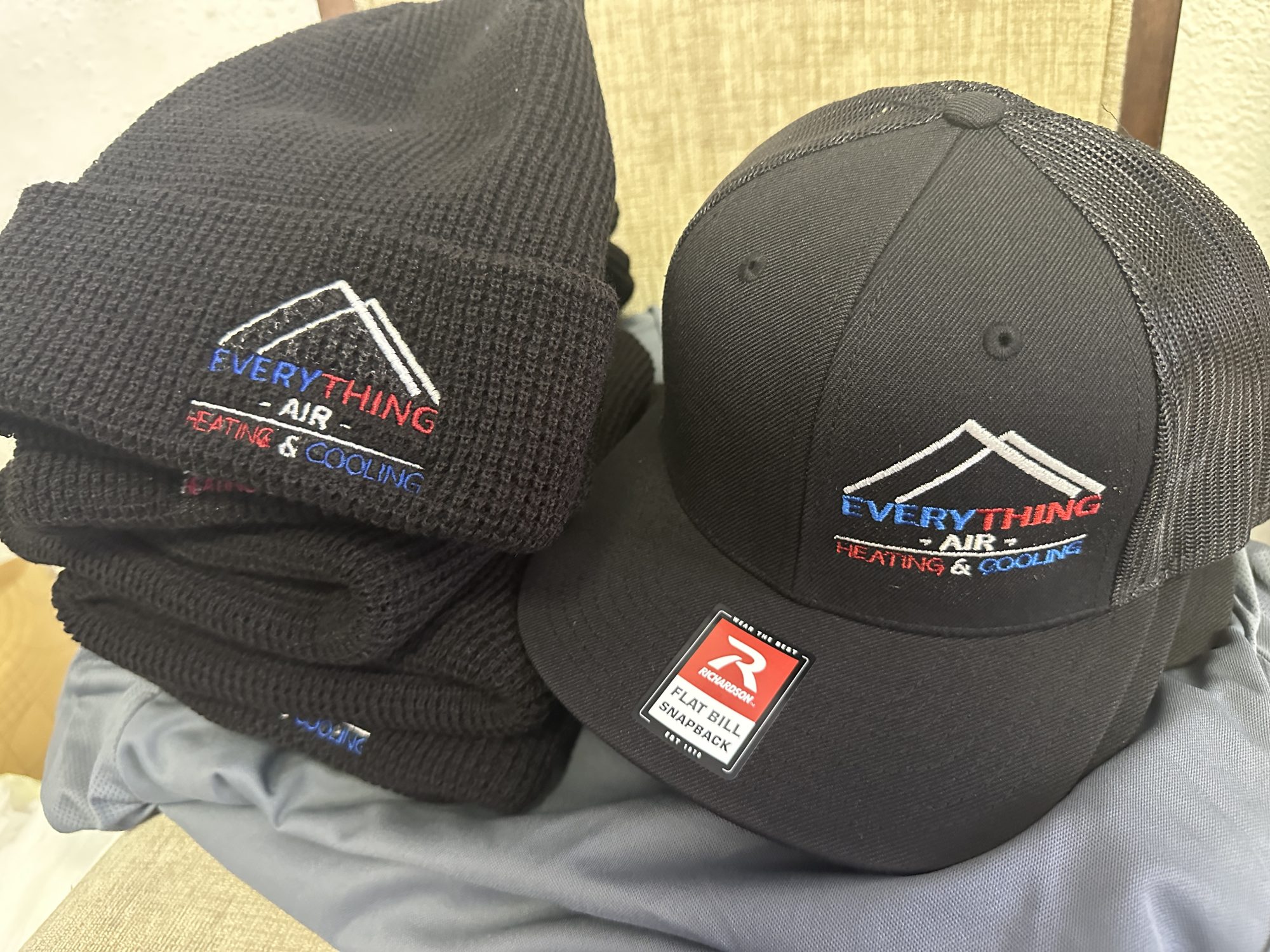 Custom embroidered baseball hats and beanies for a local company
