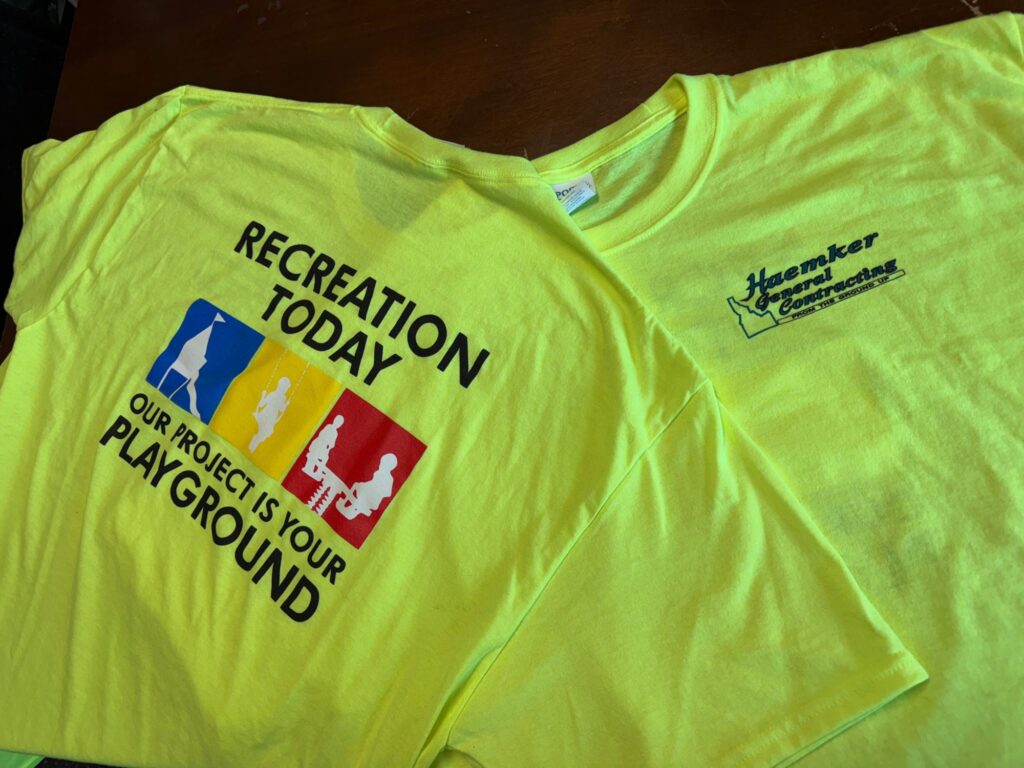 Custom screen printed shirts with front and back placement on safety green shirts for a construction company near Nampa