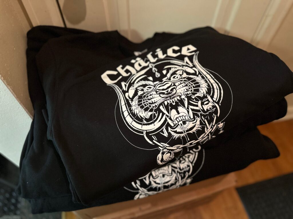 Bulk custom t-shirts with white-on-black screen printing at The Print Plug in Nampa