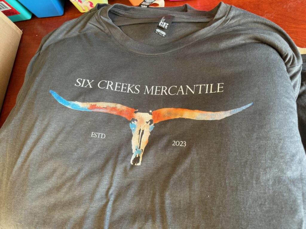 Customized graphic tee with watercolors by The Print Plug in Nampa