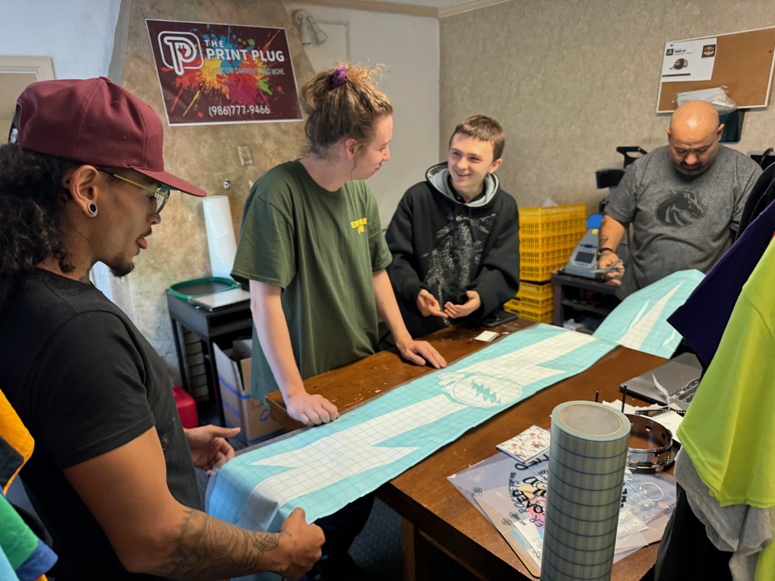 The Print Plug team looking at a large format wall decal in Nampa