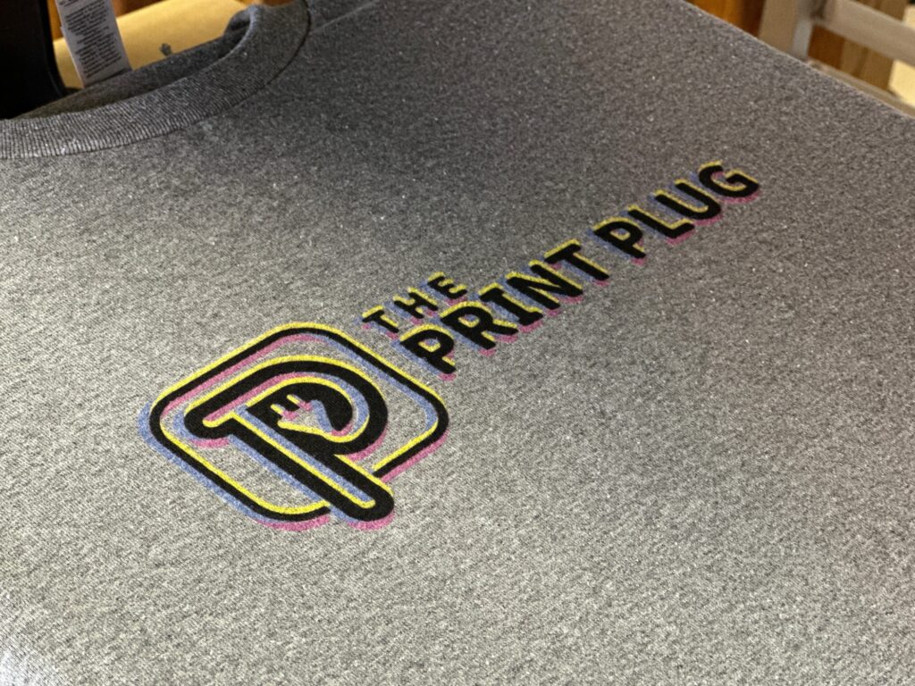 The Print Plug company logo printed onto a custom graphic tee by DTG printing