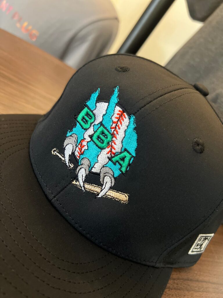 Custom embroidered hat for a local sports team from The Print Plug embroidery shop