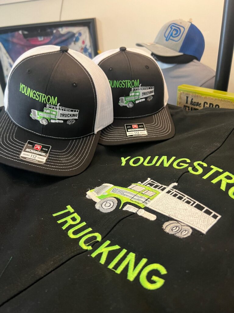 Custom embroidered hats and jackets at The Print Plug embroidery shop in Nampa