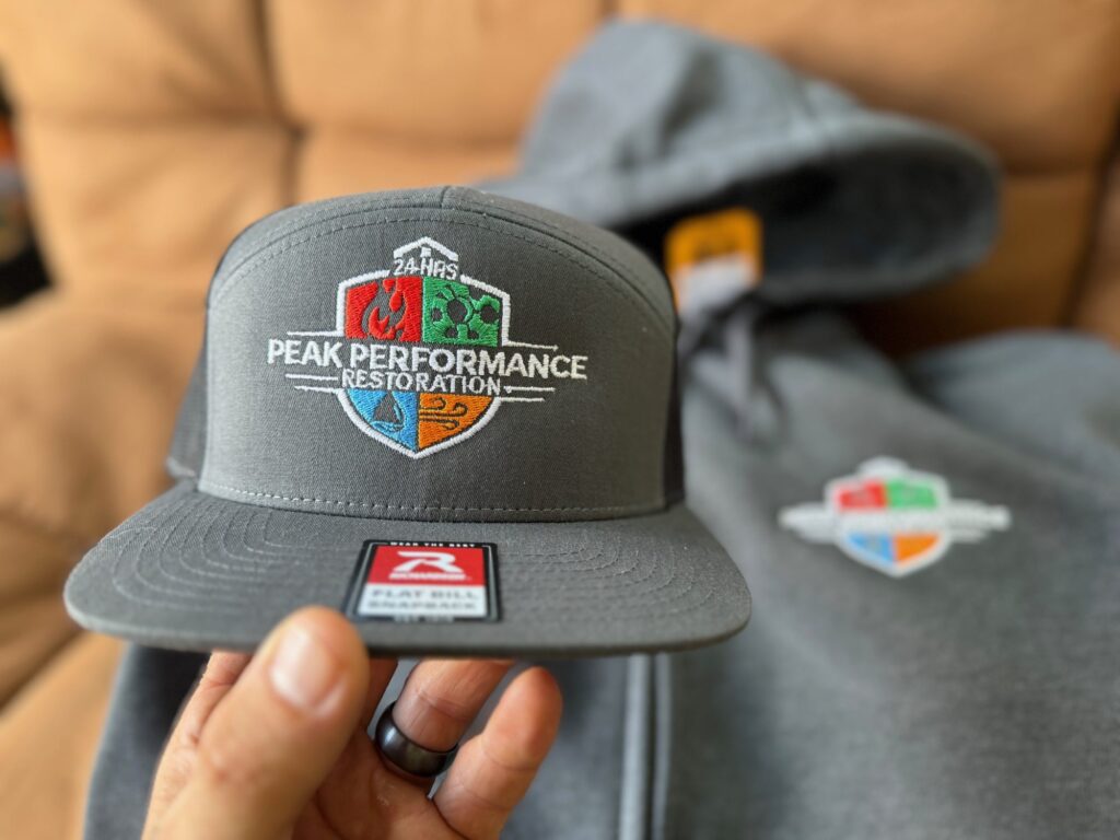 Custom embroidered hat and a custom embroidered hoodie for a local company near Nampa