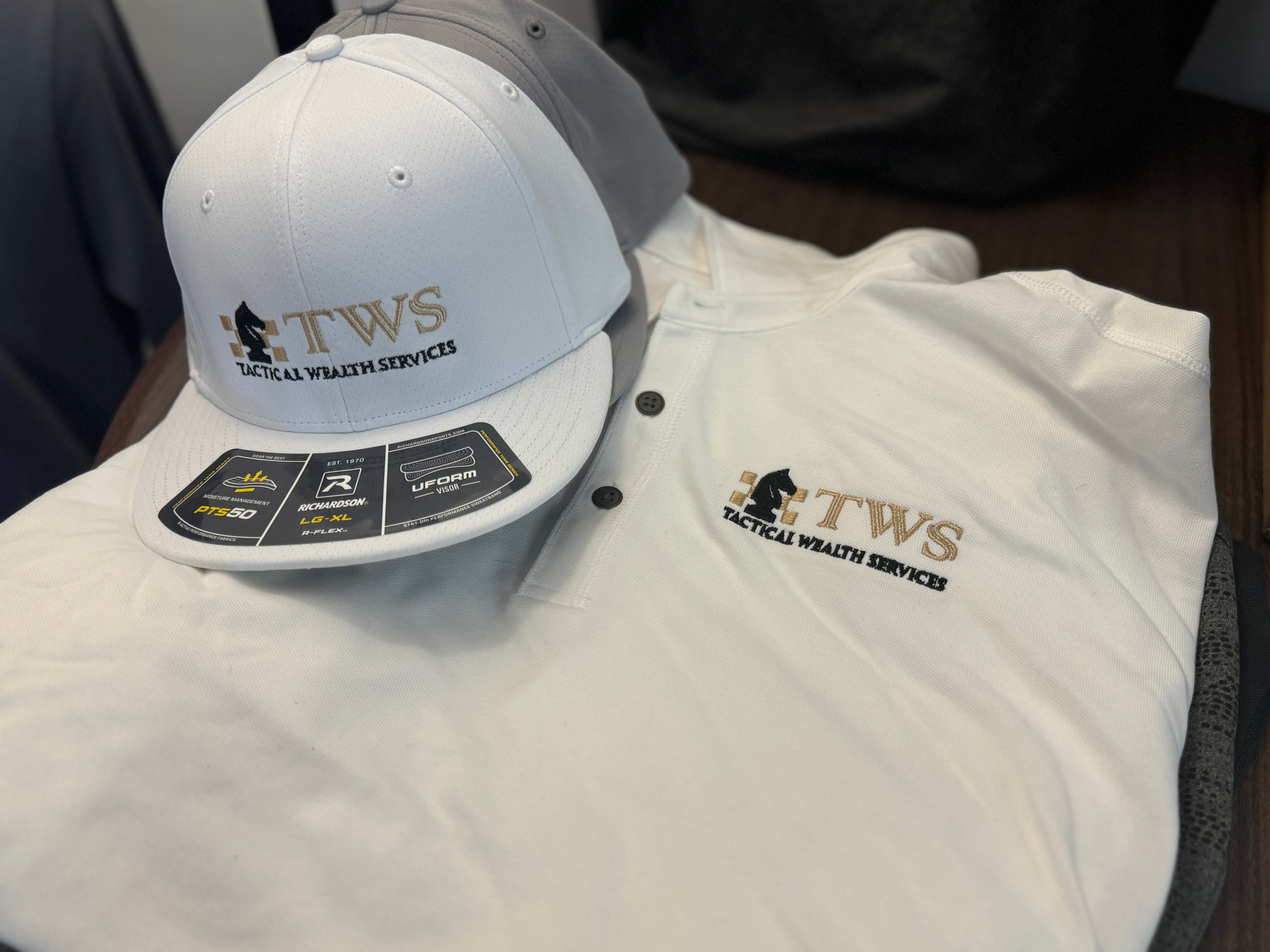 Custom embroidered hat with a custom embroidered polo shirt from The Print Plug for a local company near Nampa