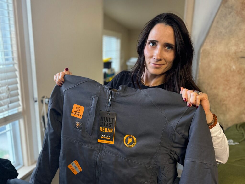 Showing off a custom embroidered jacket with left chest logo embroidered on heavy duty Carhartt.