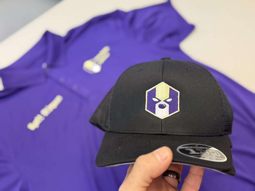 Custom embroidered polo and baseball hat for local business