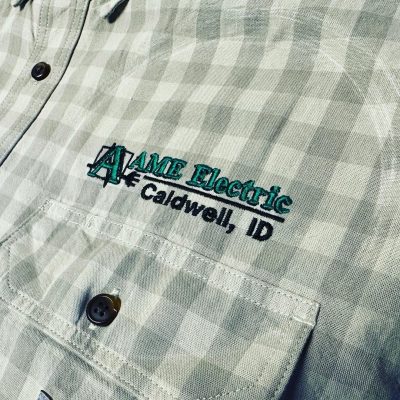 Custom logo embroidered onto a flannel shirt