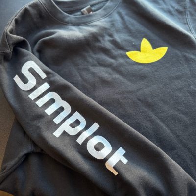 Custom screen printed shirts with left chest and sleeve placement for a large company in Nampa