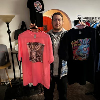 Customer showing their custom graphic tees made same-day by The Print Plug in Nampa