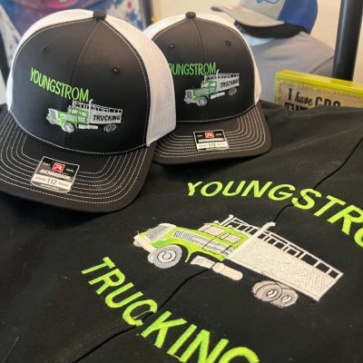 Custom embroidered hats and jackets at The Print Plug embroidery shop in Nampa