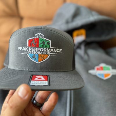 Custom embroidered hat and a custom embroidered hoodie for a local company near Nampa