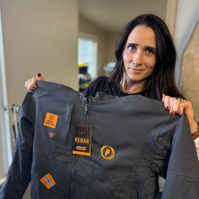 Showing off a custom embroidered jacket with left chest logo embroidered on heavy duty Carhartt.