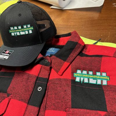 Custom embroidered hat with custom embroidered flannel for a local business near Nampa