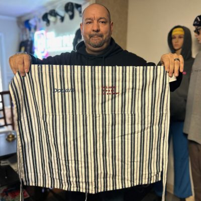 Showing off a custom embroidered apron from The Print Plug in Nampa