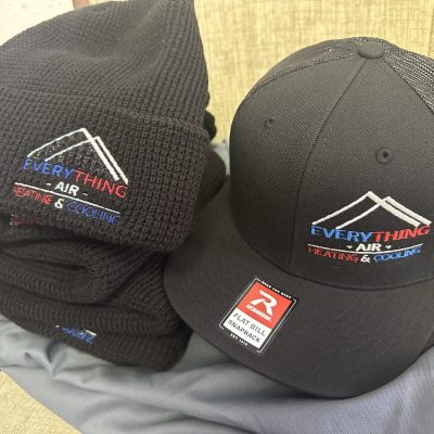 Custom embroidered baseball hats and beanies for a local company