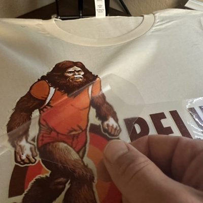 Applying an HTV print onto a custom t-shirt at The Print Plug in Nampa