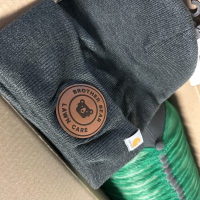 Custom leather patch on a beanie for a local business in Nampa