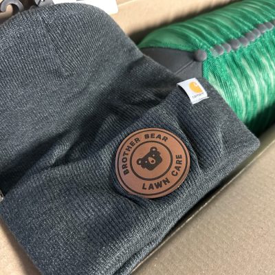 Custom leather patch on a beanie for a local business in Nampa