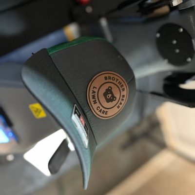 Custom leather patch being applied to a beanie at The Print Plug in Nampa