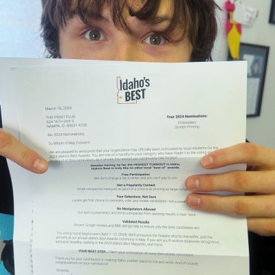 Print Plug team member showing off our nomination to Idaho's Best Screen Printing & Embroidery Shop