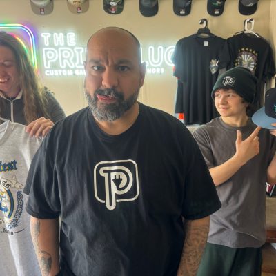 The Print Plug team posing in the front lobby at the shop in Nampa