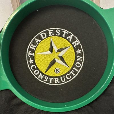 Custom logo for a business still on the hoop at the embroidery shop