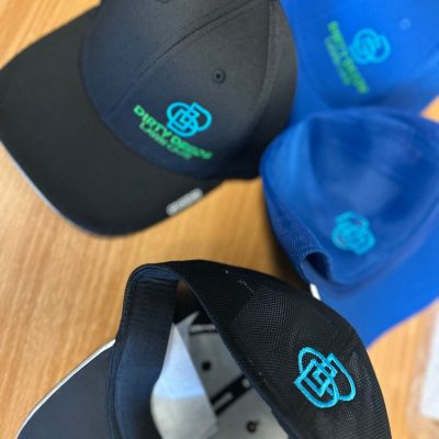 Embroidered hats displayed together, front placement and back placement