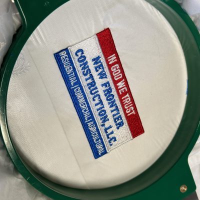 Embroidered patch on the hoop at The Print Plug embroidery shop in Nampa