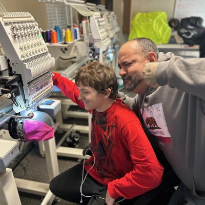 Print Plug team mate acting out in the embroidery room