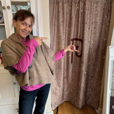 Print Plug team mate showing off a new curtain she made for the shop