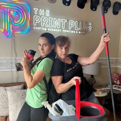 Team members of The Print Plug cleaning the shop in Nampa